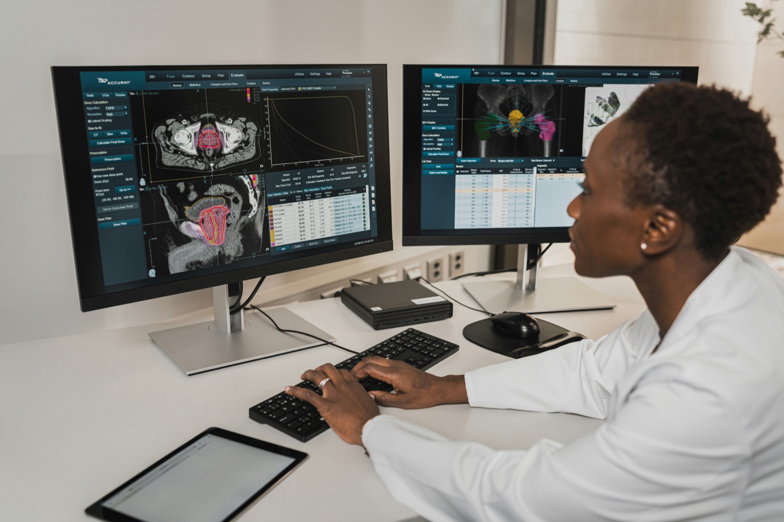 A clinical informatics nurse reviewing medical imaging on dual monitors